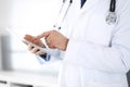 Doctor man using tablet computer for network research or virtual disease treatment, hands close-up. Perfect medical Royalty Free Stock Photo