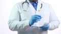 Doctor man in a white coat makes a journal entry, close-up Royalty Free Stock Photo