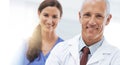 Doctor, man and woman in portrait with arms crossed for health, wellness and team in hospital. Mature healthcare expert Royalty Free Stock Photo