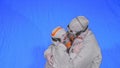 Doctor man and woman in protective costume suit, gas protect medical spray paint mask. Love couple kiss and hug, health Royalty Free Stock Photo