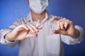 Doctor in mask with a injection syringe on the blue background Royalty Free Stock Photo