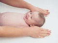Doctor massage small caucasian baby