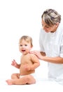 Doctor massaging or doing gymnastics smiling baby Royalty Free Stock Photo