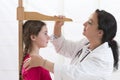 Doctor measurement the girl stature Royalty Free Stock Photo