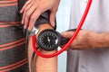 Doctor measures the bood pressure by reading display Royalty Free Stock Photo