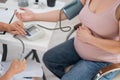 The doctor measures the pressure of a pregnant woman. Royalty Free Stock Photo