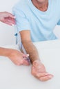 Doctor measuring arm with goniometer Royalty Free Stock Photo