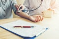 Doctor Measuring arterial blood pressure woman patient on arm He Royalty Free Stock Photo