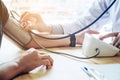 Doctor Measuring arterial blood pressure woman patient on arm He Royalty Free Stock Photo