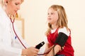 Doctor measuring blood pressure of child