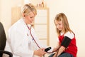 Doctor measuring blood pressure of child Royalty Free Stock Photo