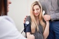 Doctor measuring blood pressure of her pregnant patient