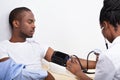 Doctor Measuring Blood Pressure Of Patient Royalty Free Stock Photo