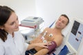 Doctor measuring blood pressure patient with electrodes Royalty Free Stock Photo