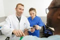 doctor measuring blood pressure patient with nurse near by Royalty Free Stock Photo