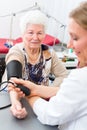 Doctor measuring blood pressure of senior patient