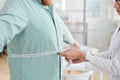 Doctor measuring obese man stomach Royalty Free Stock Photo