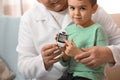 Doctor measuring patient`s blood sugar level with digital glucose meter at home, closeup Royalty Free Stock Photo