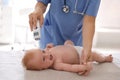 Doctor measuring temperature of baby with non-contact thermometer in clinic, closeup. Health care Royalty Free Stock Photo