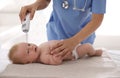 Doctor measuring temperature of little baby with non-contact thermometer in clinic, closeup. Health care Royalty Free Stock Photo