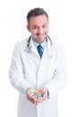 Doctor or medic holding both palms full of pills