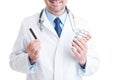 Doctor or medic holding pills blisters and credit card