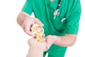 Doctor, medic or pharmacist pouring pills in patient hand Royalty Free Stock Photo