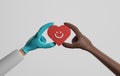 Doctor in medical gloves and african american patient holding heart, happy face on white background