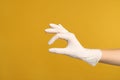 Doctor in medical gloves showing OK gesture on yellow background, closeup. Space for text Royalty Free Stock Photo