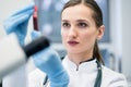 Doctor in medical laboratory looking at blood test