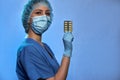 Doctor in medical mask, gloves and cap with blister with pills in hand. Coronavirus disease COVID-19, epidemic Royalty Free Stock Photo