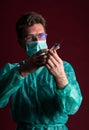 Doctor in medical mask make protective injection. Nurse in glasses prepare syringe.