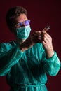 Doctor in medical mask make protective injection. Nurse in glasses prepare syringe.