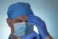 The doctor in medical mask puts surgical gloves. Selective focus. Hospital concept