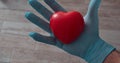 doctor, medical nurse holds a heart and squeezes it, heart prevention and care day concept, care and self love, with zoom-in out