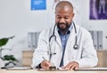 Doctor, medical office and black man writing notes, form or life insurance paperwork for planning healthcare results