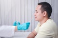 Doctor or medical staff is collecting secretions from patient for examination in the lab. Pandemic Coronavirus, COVID-19