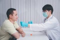 Doctor or medical staff is collecting secretions from patient for examination in the lab. Pandemic Coronavirus, COVID-19