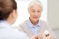 Doctor with medicine and senior woman at hospital Royalty Free Stock Photo