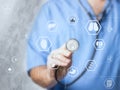 Doctor medicine with stethoscope in a hospital touching icon network connection with modern virtual screen interface Royalty Free Stock Photo