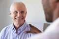 Doctor Meeting With Mature Male Patient In Exam Room Royalty Free Stock Photo