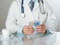 Doctor with money Royalty Free Stock Photo