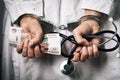 Doctor with money in handcuffs. The concept of corruption in medicine and bribery