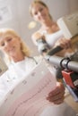 Doctor Monitoring Female Patient On Treadmill