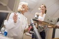 Doctor Monitoring Female Patient On Treadmill