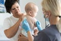 doctor with newborn on a white