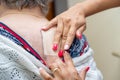 Doctor or nurse applying medical patch to senior woman at hospital.