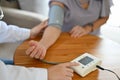 Doctor or nurse checking patient`s blood pressure with blood pressure monitor Royalty Free Stock Photo