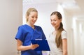 Doctor or nurse with clipboard and girl patient