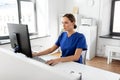 Doctor or nurse with computer working at hospital Royalty Free Stock Photo